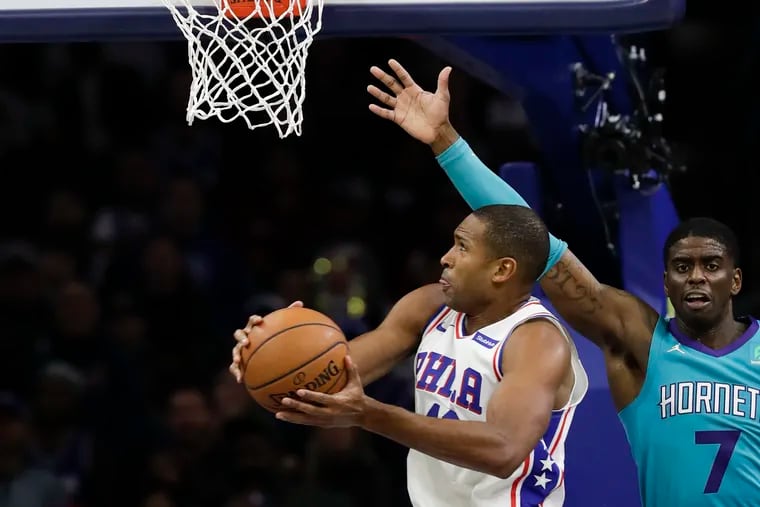 Sixers forward Al Horford drives to the basket past Charlotte Hornets guard Dwayne Bacon on Sunday, November 11, 2019 in Philadelphia.