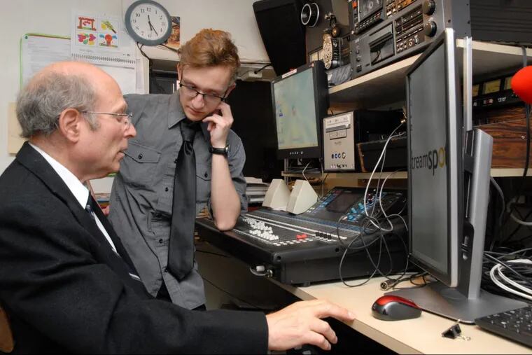 Control room technician Richard Meyer (left) and his son, Bryan Fine, 18,  prepare to  live-stream Shabbat services at Reform Congregation Keneseth Israel in Elkins Park.