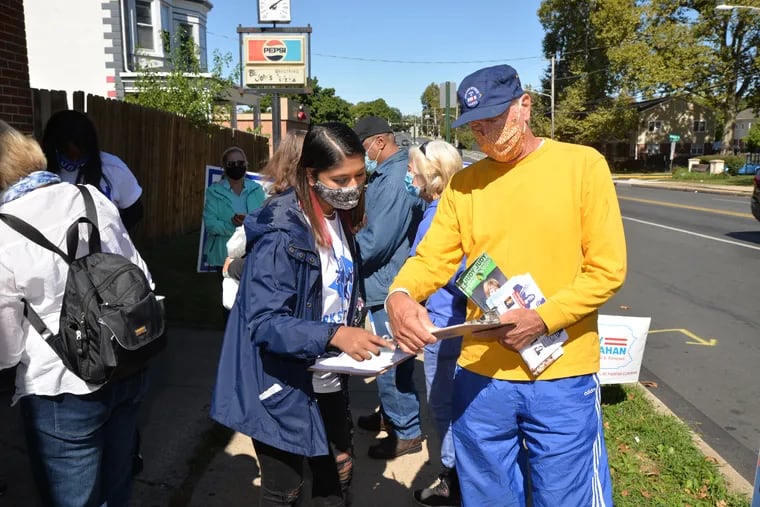 A volunteer provides neighborhood charts as the Berks County Democratic Committee goes door to door registering voters on Sept. 19, 2020.