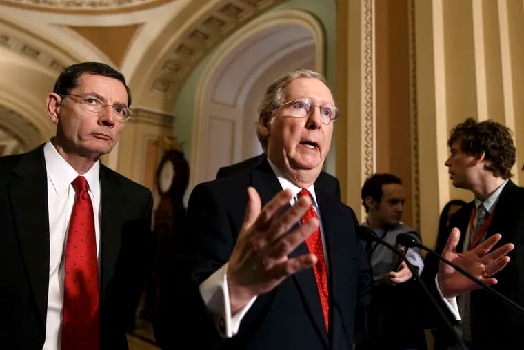 Minority Leader Mitch McConnell (R., Ky.), with Sen. John Barrasso (R., Wyo.), speaks to reporters after the Senate's rejection of Debo Adegbile.