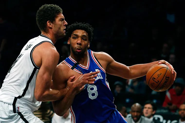 Brooklyn Nets center Brook Lopez (11) defends against Philadelphia 76ers center Jahlil Okafor (8) during first half at Barclays Center.