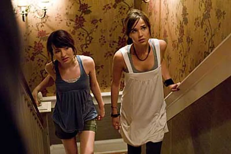 Anna (Emily Browning), left, and Alex (Arielle Kebbel) are suspicious of their father’s new fiancée in "The Uninvited."