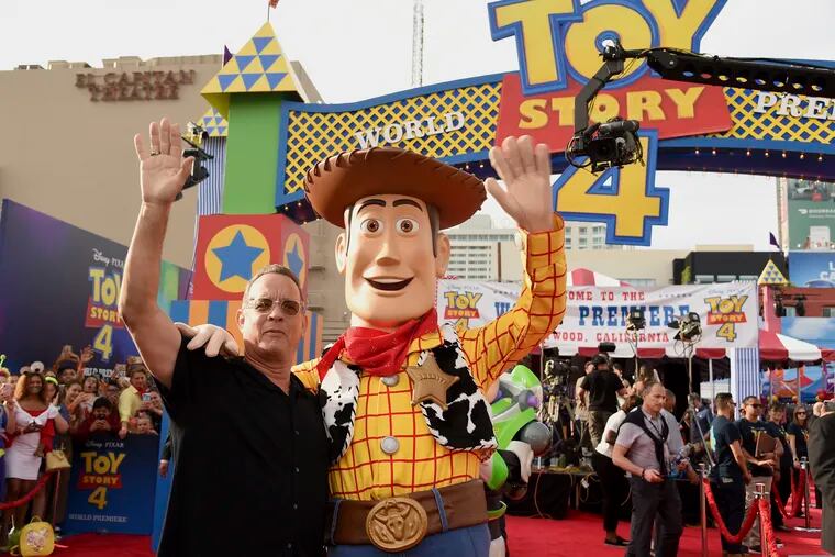 Tom Hanks, left, poses with his character Woody as he arrives at the world premiere of "Toy Story 4" on Tuesday, June 11, 2019, at the El Capitan in Los Angeles. (Photo by Chris Pizzello/Invision/AP)