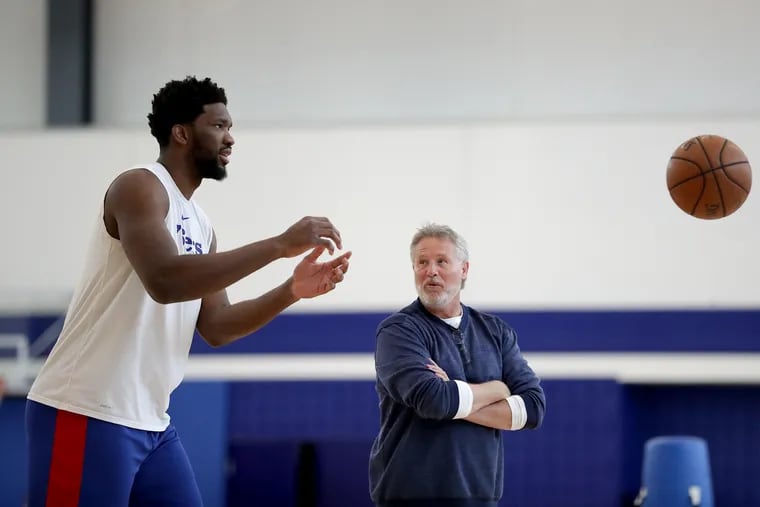 Philadelphia 76ers head coach Brett Brown (right) talks with Joel Embiid during a practice session on Friday.