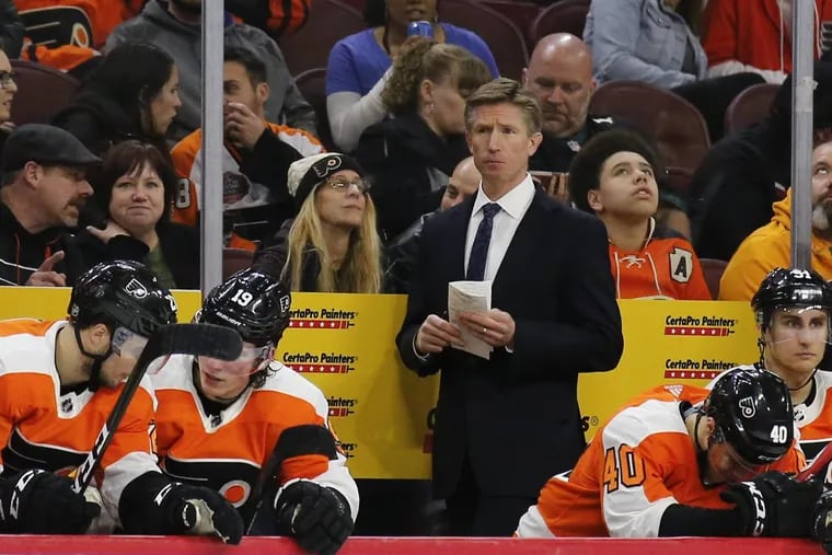 Flyers coach Dave Hakstol watching his team against the Lightning on Thursday  night.