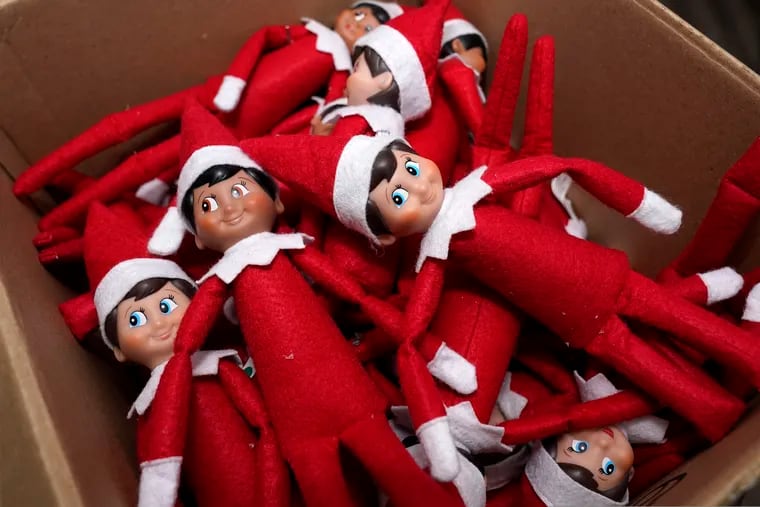 Elf on the Shelf figures are piled in a box at the company's studio Thursday, Aug. 27, 2020, in Atlanta.