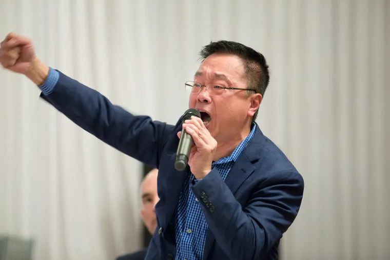 Adam Xu, chairman of the Asian American Licensed Beverage Association of Philadelphia, speaks passionately Friday during an emergency meeting of the association on a Council bill that would authorize city officials to remove protective bullet-resistant windows in places that serve food and alcohol.