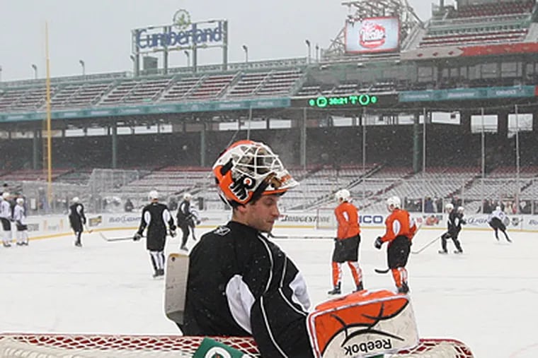 Flyers goalie Michael Leighton takes a quick water break during practice at Fenway Park yesterday. (Michael Bryant / Staff photographer)