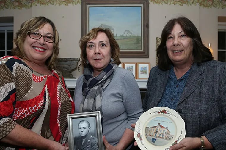 Lorie Jaworski, left, Fran Peltier, center, and, Dorothy Jaworski, right, pose with a photo of Stephen Jaworski, who was honored for his service in World War II.  (Andrew Thayer / Staff Photographer)