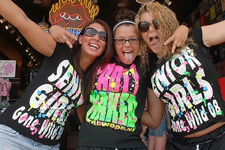 Get the message? Nicole Caggiano (left), 17, Britany Lewis (center), 17, and Beth Fenton, 18, all from Woodbridge, N.J., show off their colorful party T-shirts at Gemini on the Boardwalk in Wildwood. (Peter Tobia/Inquirer)