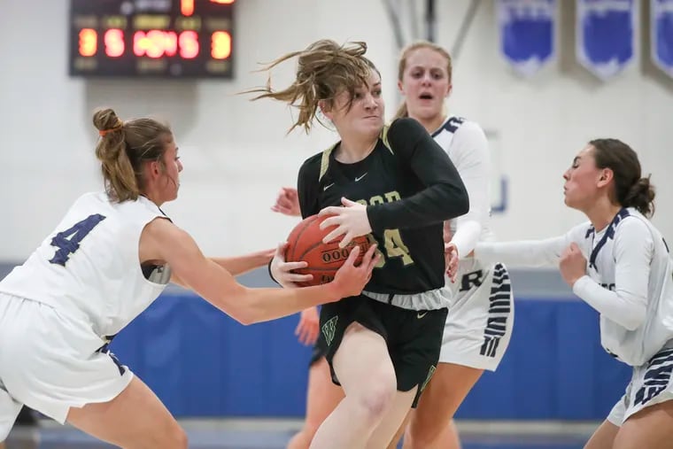 Archbishop Wood’s Alexa Windish drives to the basket past Rustin defenders in the first half of a PIAA 5A semifinal game at Bensalem High School on March 21.