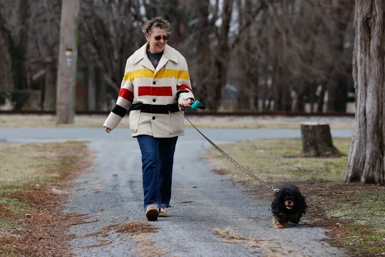 Breast cancer survivor Heather Klebon walks her dog, Faith, in her Clayton, Del., neighborhood on Jan. 27.  Klebon was involved in the Penn Medicine proton radiation treatment for her breast cancer and has been cancer free for the last two and half years.