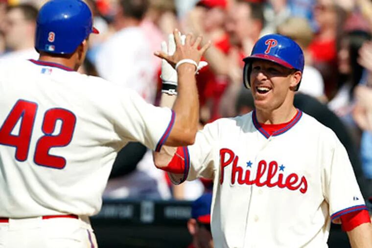 Hunter Pence celebrates with Pete Orr after Pence scored as the Phillies took the
lead 3-2. (David Maialetti  / Staff Photographer)
