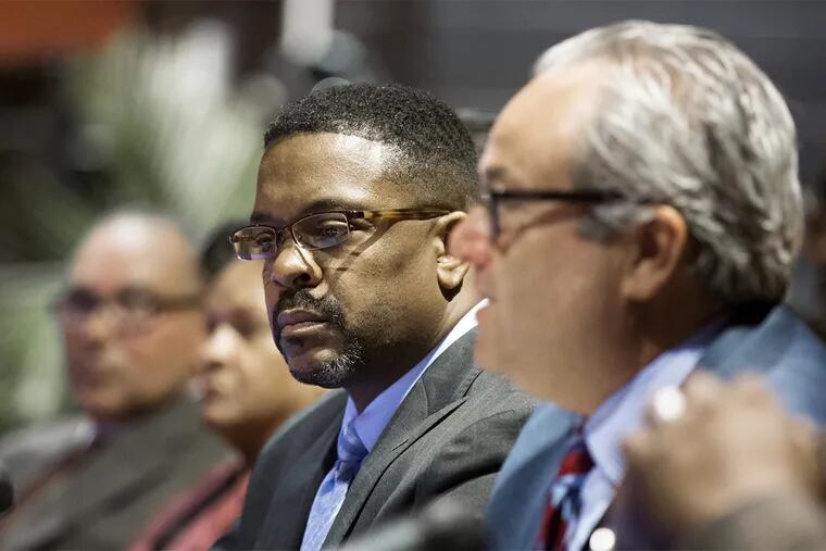Rev. Ken Gordon (left) appears lost in thought as he listens to fellow panelist attorney Greg Zeff speak during a "Justice for All Matters" forum at the Gloucester County Institute of Technology in Sewell.