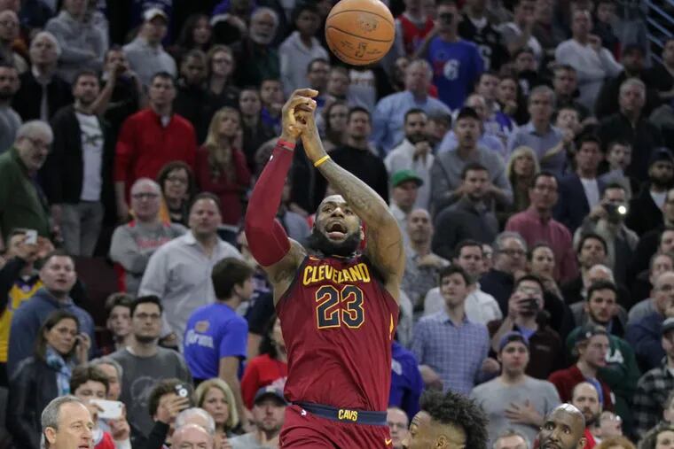 Cavs superstar LeBron James gets fouled going up for a game-tying three against the Sixers on Friday.
