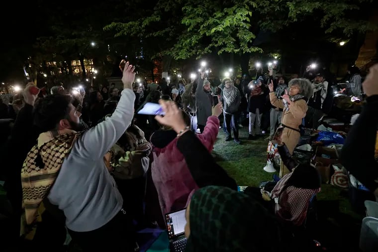 Supporters of Palestine sing songs on College Green in the heart of the University of Pennsylvania campus in Philadelphia on Friday night, April 26, 2024.
