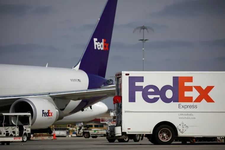 A delivery truck parked near a cargo jet at the FedEx Express Hub in Memphis in March. The company reported a decline in global shipping volumes in September.