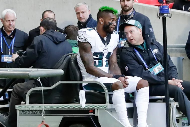 Jalen Mills gets carted off after an injury during the Eagles' win over Jacksonville in London in October.
