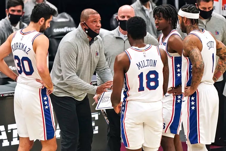 Philadelphia 76ers head coach Doc Rivers talks with players during a timeout in the first half against the Cleveland Cavaliers, Sunday, Dec. 27, 2020.