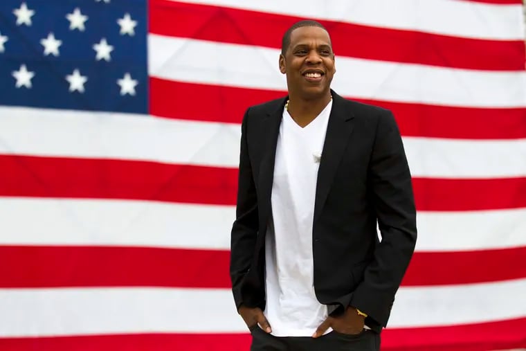 FILE – In this May 14, 2012 file photo, entertainer Jay-Z smiles after a news conference at Philadelphia Museum of Art in Philadelphia. The rapper says he's disappointed his "Made in America" festival will not be held in Philadelphia after this year. The Philadelphia Inquirer reports the city confirmed Tuesday, July 17, 2018, that the annual concert won't be on the Benjamin Franklin Parkway anymore.(AP Photo/Matt Rourke, file)