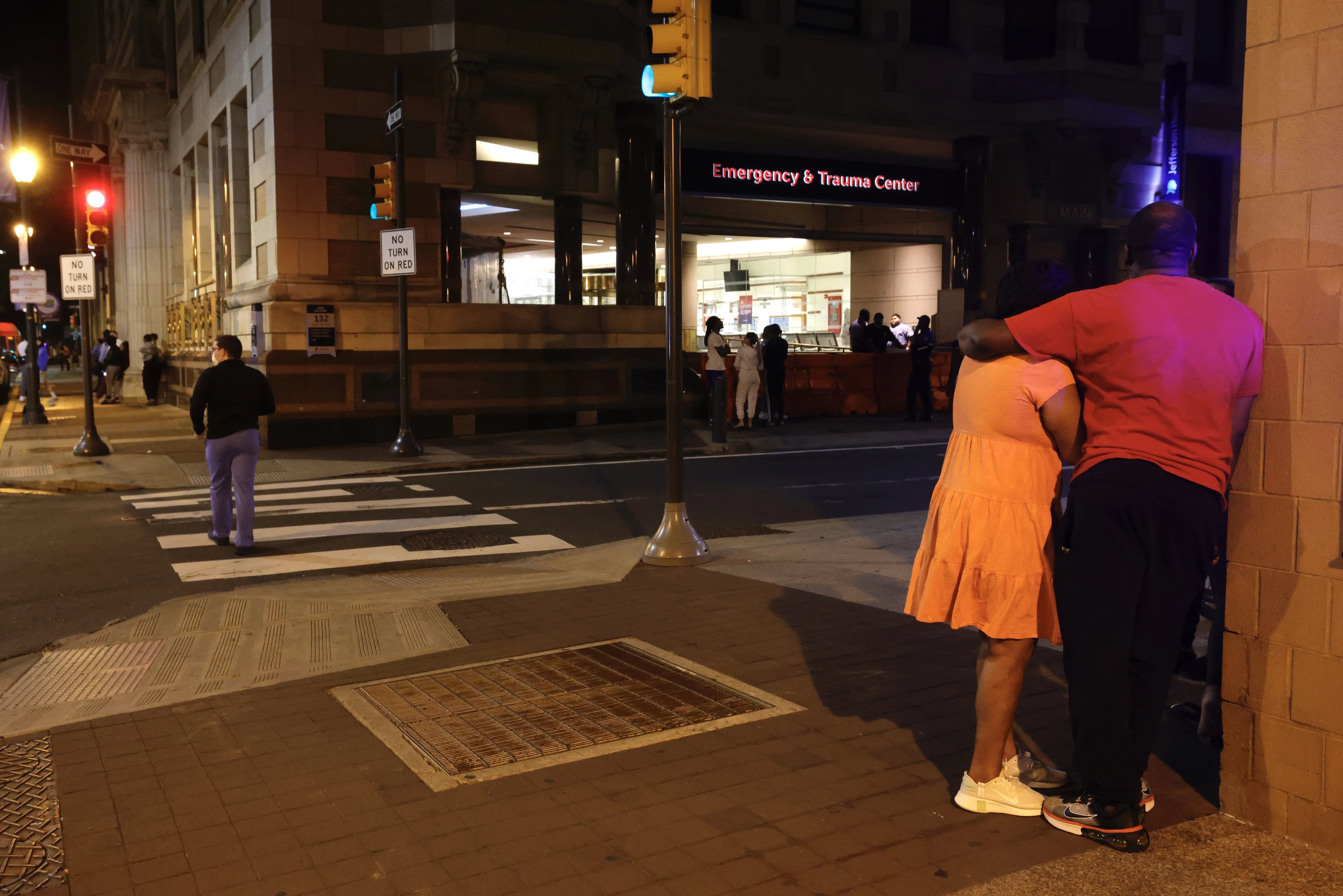 Friends and family gather outside Thomas Jefferson University Hospital Emergency Department early Sunday morning, June 5, 2022, where victims of a mass shooting on South Street in Philadelphia were brought for treatment.