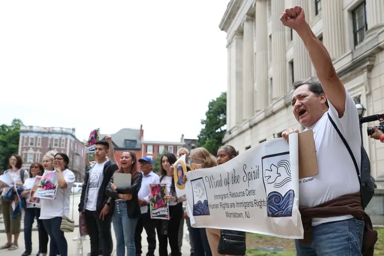 Jose L. Torralba raises his fist during a rally outside of the State House Annex in Trenton, N.J., on Wednesday.