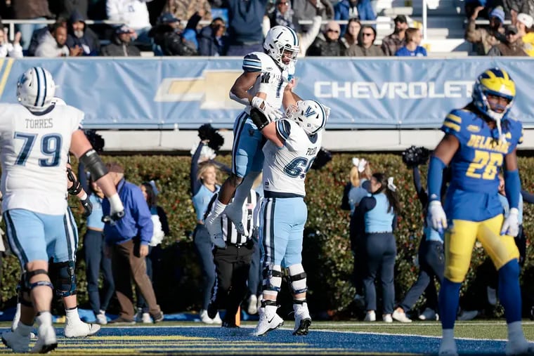 Villanova’s Ayo-Durojaiye is lifted into the air by teammate Jake Picard after scoring a touchdown against Delaware on Nov. 18.