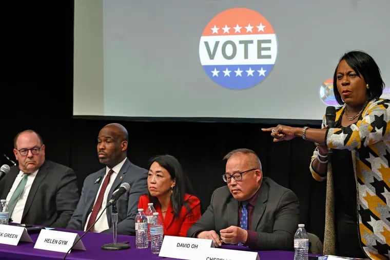 Mayoral candidate Cherelle Parker (right) speaks during a March 14 mayoral forum at Gloria Casarez Elementary School in Kensington. The candidates have been invited to a Philadelphia school board mayoral forum focusing on education issues, scheduled for Tuesday night.