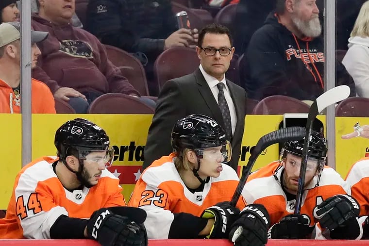 Flyers interim coach Scott Gordon watches the action behind (from left to right) Phil Varone, Oskar Lindblom, and Sean Couturier during a recent game.