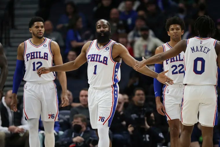 Philadelphia 76ers guard James Harden (1) slaps hands with guard Tyrese Maxey (0) during the first half of the team's NBA basketball game against the Minnesota Timberwolves, Friday, Feb. 25, 2022, in Minneapolis. (AP Photo/Stacy Bengs)