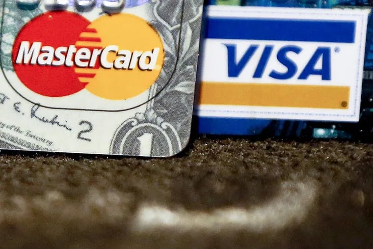 In this Jan. 31, 2018, photo, Master Card and Visa logos on credit cards is shown in Zelienople, Pa.