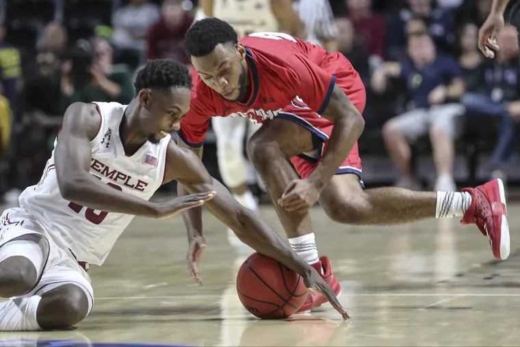 Temple's Shizz Alston Jr. and Detroit Mercy's Josh McFolley scramble for the loose ball during the 1st half at The Liacouras Center in Philadelphia Friday, November 9, 2018. STEVEN M. FALK / Staff Photographer