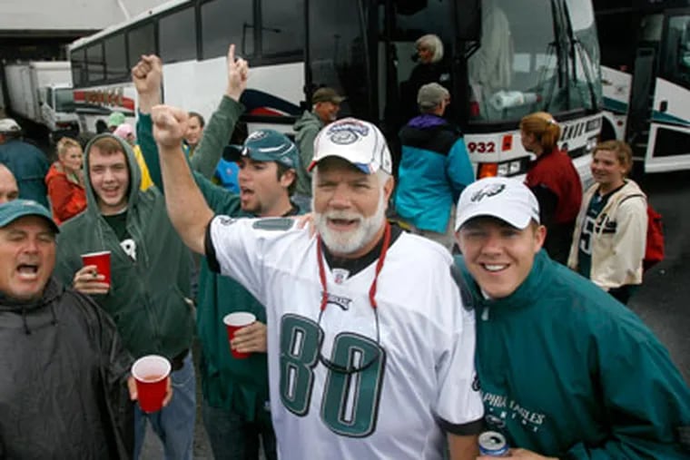As they prepare to head into the Eagles/Chiefs game, Ron Smith leads the bus in the Eagles chant. The group has been chartering buses to Eagles games for 50 years. (Charles Fox / Staff Photographer)