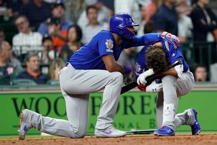 Cubs outfielder Albert Almora Jr., right, is comforted by teammate Jason Heyward after hitting a foul ball that struck a child in the stands during the fourth inning of Wednesday's game against Houston.