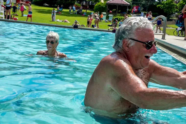 Haddon Township residents Jeraldine Schachte (left), 70, and Larry Richio, 69, enter the pool at the start of  "adult swim" at the Crystal Lake Pool Tueday, June 23, 2020. Schachte first came to the pool as a teenager, when it was a lake with a sandy bottom.