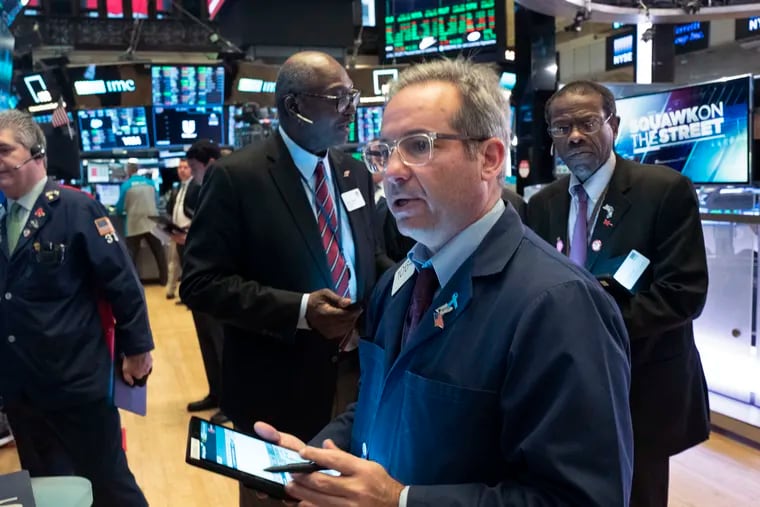 Stock traders work at the New York Stock Exchange on Tuesday.