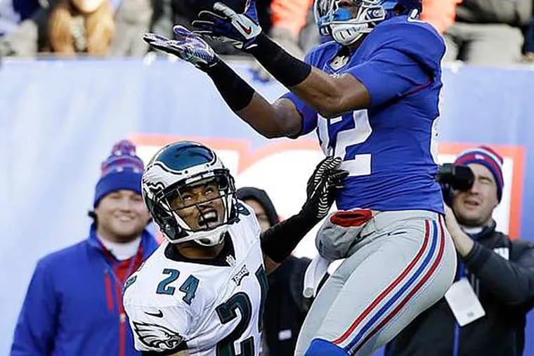 Giants wide receiver Rueben Randle (82) catches a pass as cornerback Nnamdi Asomugha (24) defends during the first half of an NFL football game on Sunday, Dec. 30, 2012, in East Rutherford, N.J. (Kathy Willens/AP)