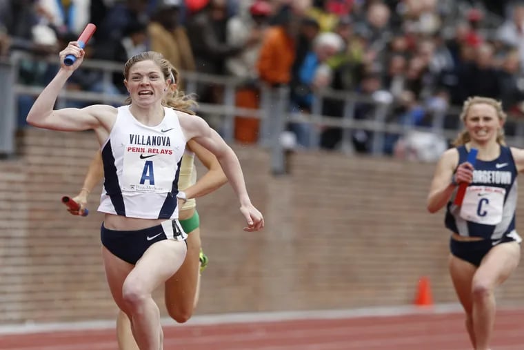 Siofra Cleirigh Buttner, left, of Villanova celebrates as she crosses the finish line in the College Women's 4x1500m Championship of America at the Penn Relays on April 29, 2016.