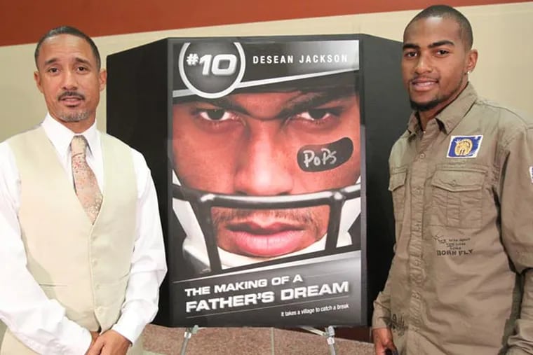 DeSean Jackson (right) and his brother Bryon pose by the poster before the screening of a movie about DeSean and his father, Bill. (Charles Fox/Staff Photographer)