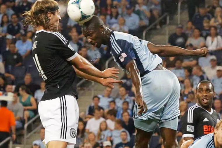 Sporting KC defender Ike Opara (3) and Philadelphia Union defender Jeff Parke, left, battle for the ball after a corner kick during the first half of an MLS soccer match in Kansas City, Kan., Friday, Sept. 27, 2013. (Orlin Wagner/AP)