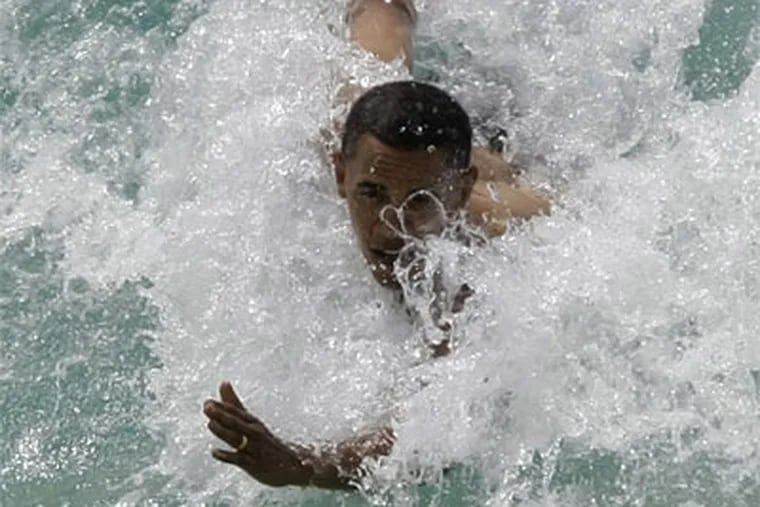 Democratic presidential candidate Sen. Barack Obama, D-Ill., body surfs at Sandy Beach in Honolulu, Hawaii during his vacation. (AP Photo/Alex Brandon)