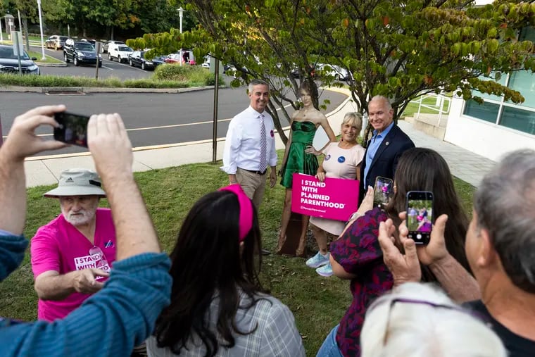 Bucks County Democratic Commissioners Bob Harvie and Diane Marseglia, and Judge Dan McCaffery who is running for the Supreme Court, pose for a photo with a life-sized Taylor Swift cutout during a rally outside of the Middletown Township Police Department and Administrative Offices in Langhorne this month.