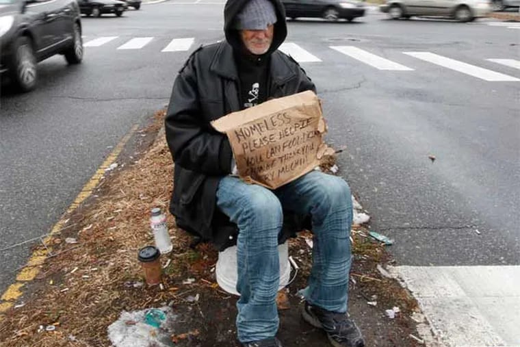 A homeless man at Roosevelt Blvd. and Devereaux Ave. in the Lower Northeast. The city's 2013 poverty rate is 26.9 pct., the highest of any U.S. city of its size. (Michael Bryant / Staff Photographer)