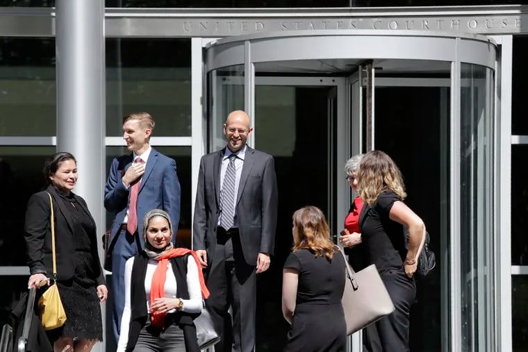 FILE - In this June 28, 2019, file photo, Matt Adams (center right), legal director of the Northwest Immigrant Rights Project, leaves the U.S. Courthouse with others after a hearing on asylum seekers in Seattle. On Tuesday, July 2, 2019, a federal judge in Seattle blocked a Trump administration policy that would keep thousands of asylum seekers locked up while they pursue their cases.