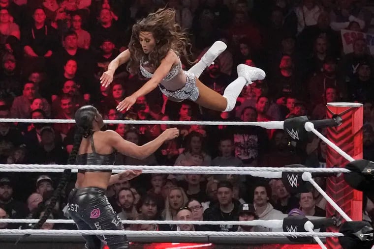 Wrestler Carmella leaps at Bianca Belair, during the WWE Monday Night RAW event, Monday, March 6, 2023, in Boston. (AP Photo/Charles Krupa)