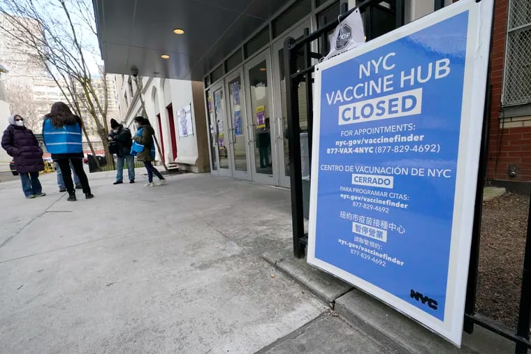 In this Jan. 21 file photo, people who had appointments to get COVID-19 vaccinations talk to New York City health care workers outside a closed vaccine hub in the Brooklyn borough of New York after they were told to come back in a week due to a shortage of vaccines. An increasing number of COVID-19 vaccination sites around the U.S. are canceling appointments because of vaccine shortages in a rollout so rife with confusion and unexplained bottlenecks.