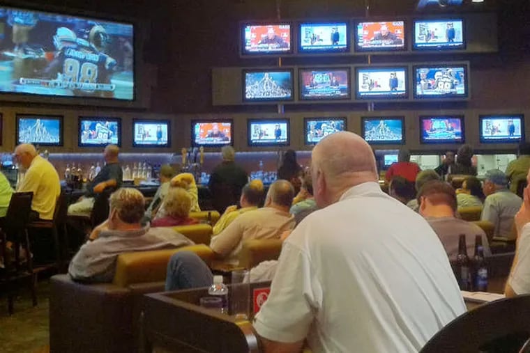 Bettors watch NFL action at Harrah's in Las Vegas. Nevada effectively is the only state with legal sports gambling.