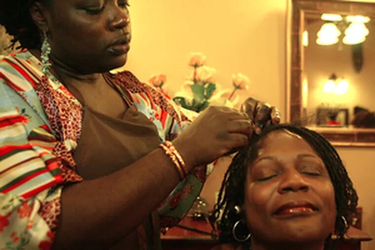 Syreeta Scott (left), owner of Duafe Holistic Hair Care, with customer Mary Mirabeau.