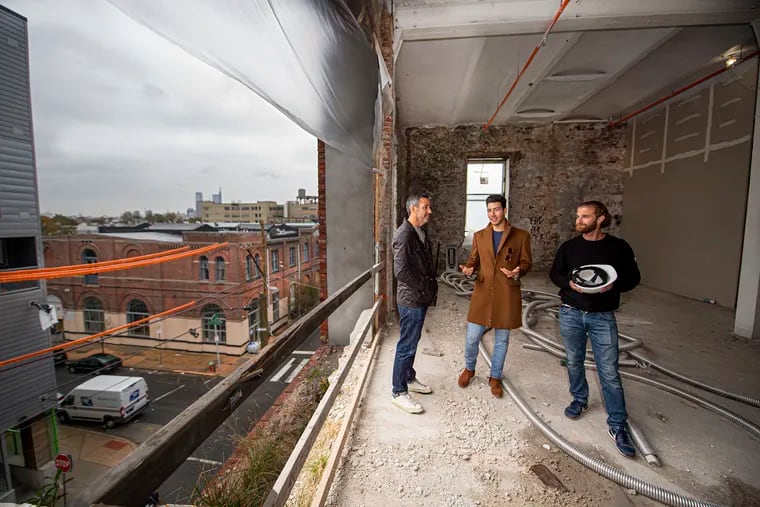 David Waxman, managing partner, MMPartners LLC (left) with partners, Joe Zimatore (center) and Aaron Smith inside a future apartment in the Poth Brewery building in Philadelphia.