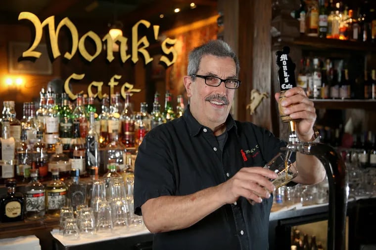 Owner Tom Peters stands for a portrait while pouring his Flemish sour ale at Monk's Cafe in Center City Philadelphia on Tuesday, July 31, 2018. TIM TAI / Staff Photographer